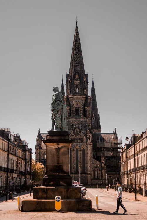 man walking near statues
