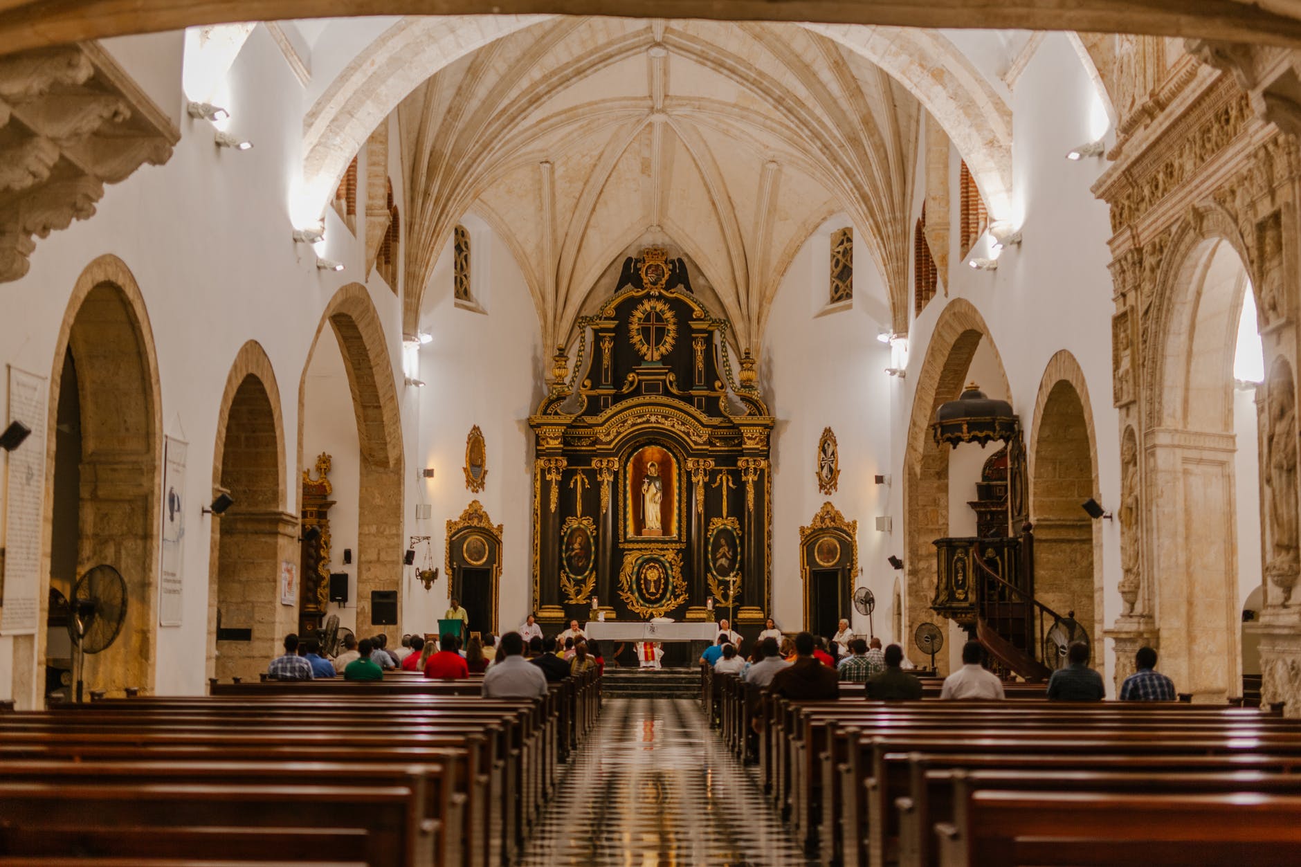 unrecognizable prayers on pews during mass in catholic cathedral