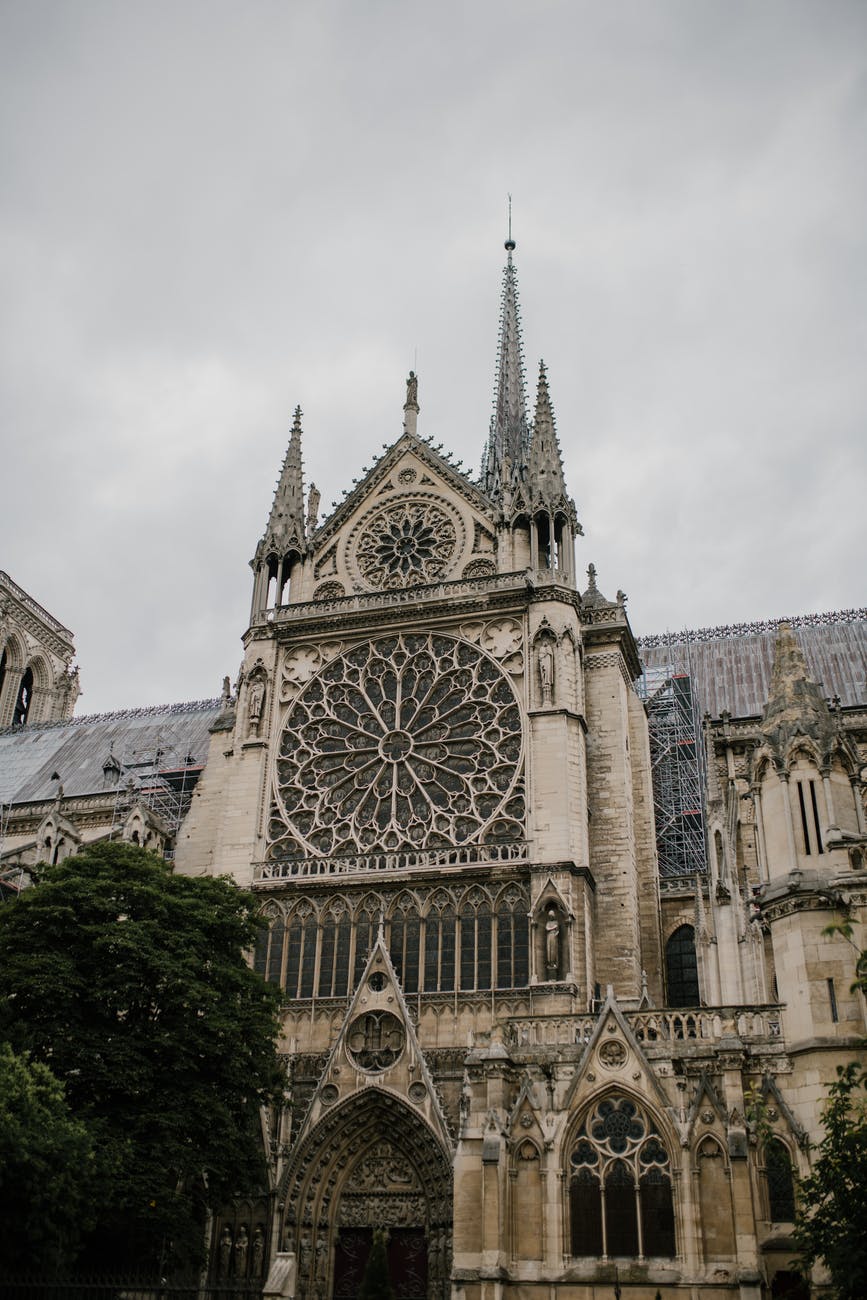 facade of old catholic cathedral with spires