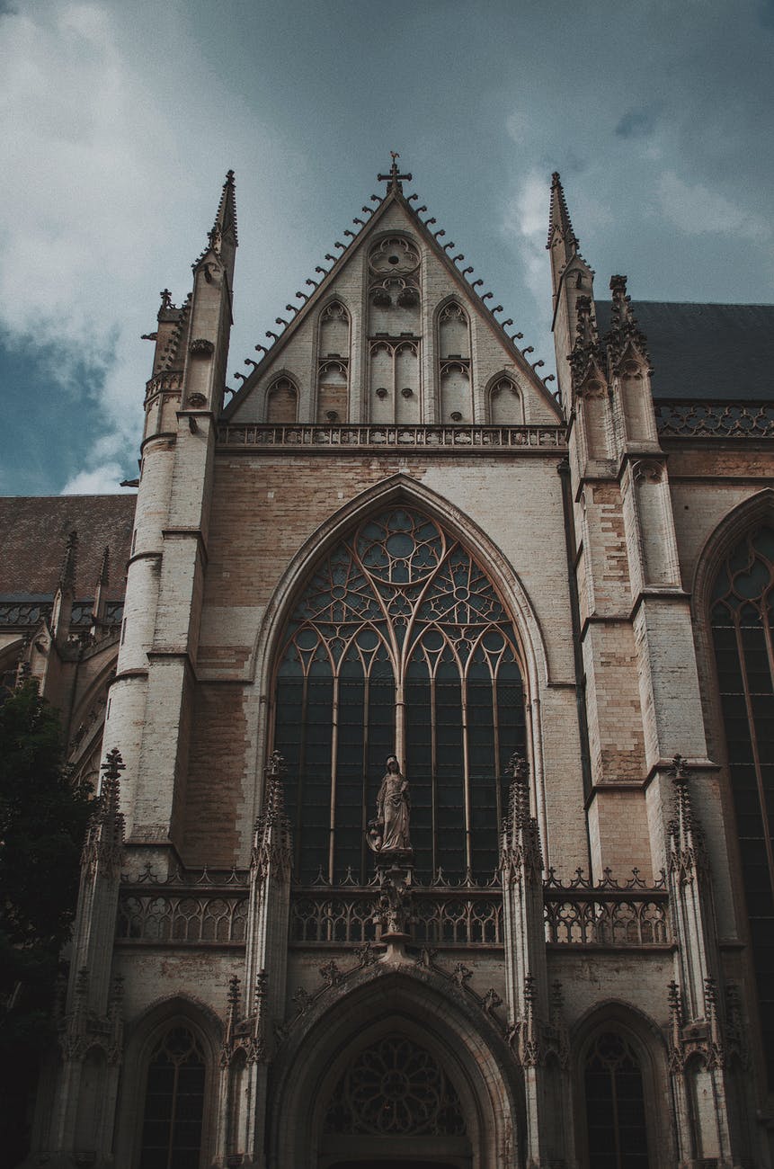 low angle photo of church under cloudy sky