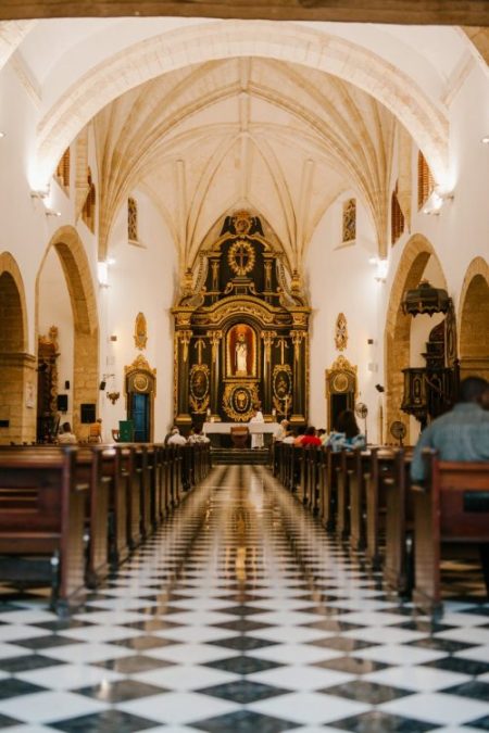ornamental church with arched ceiling and wooden benches