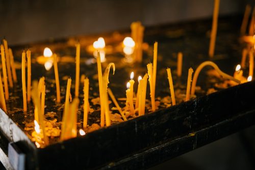 glowing candles in holy place of church